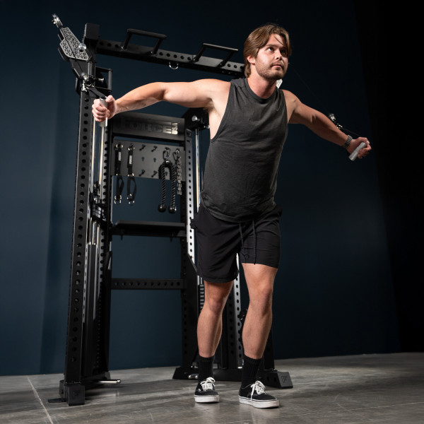 User performing cable fly on the Force USA Functional Trainer Rack