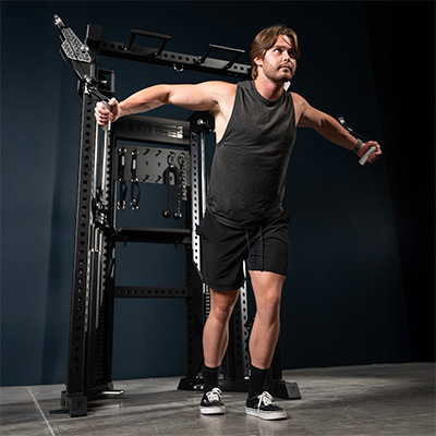 User performing cable fly on the Force USA Functional Trainer Rack