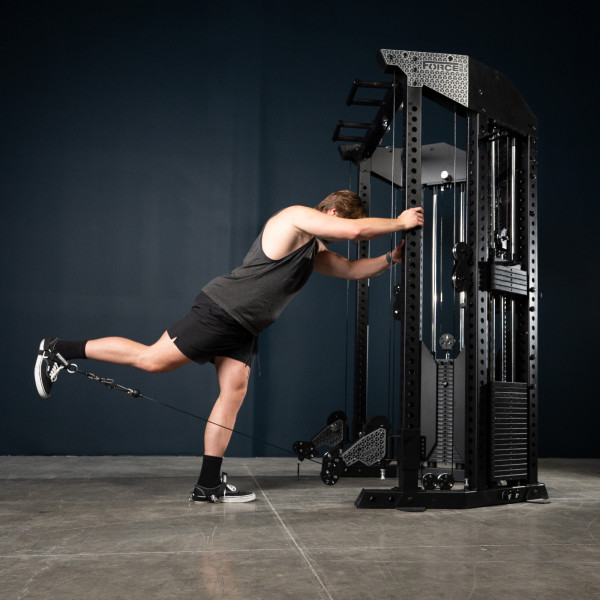 User doing cable kickback on the Force USA Functional Trainer Rack