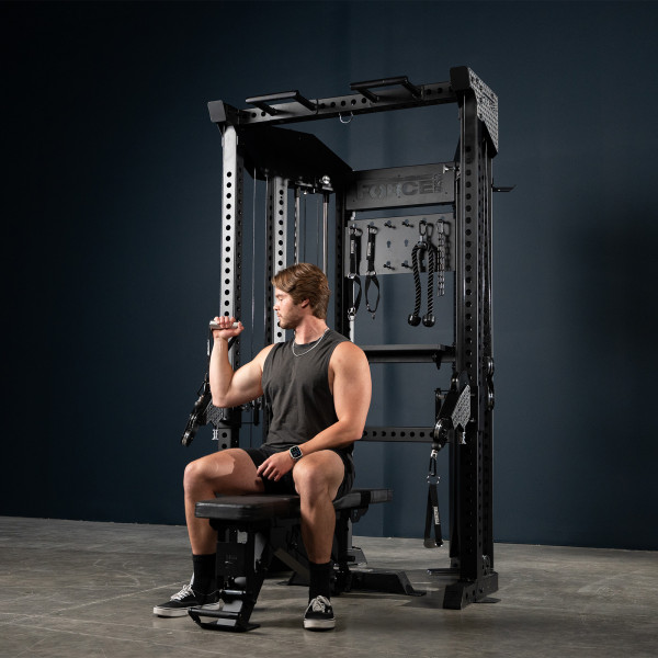 User seated for bicep curl on the Force USA Functional Trainer Rack