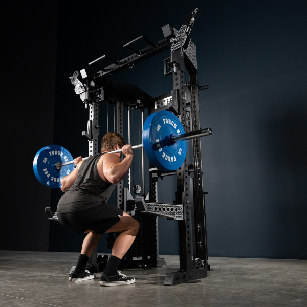 User squatting with barbell on the Force USA Functional Trainer Rack