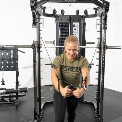 User performing a cable crossover exercise on the Force USA G12 V2 All-In-One Trainer.
