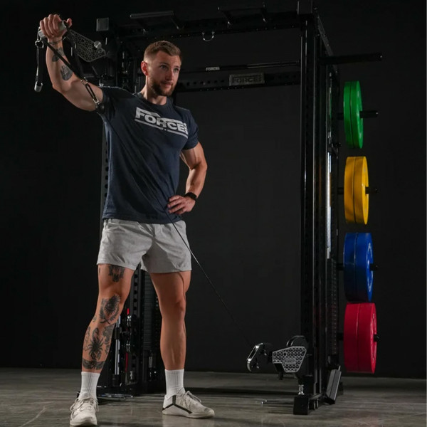 Lifestyle image of the Force USA M20 All-In-One Trainer - Image of a model performing a cable lateral raise