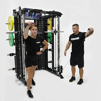 Two users performing cable exercises on the Force USA G15 All-In-One Trainer 
