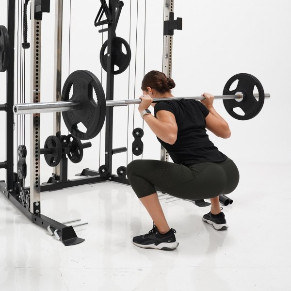 User performing deep squats on the Force USA G1 V2 All-In-One Trainer