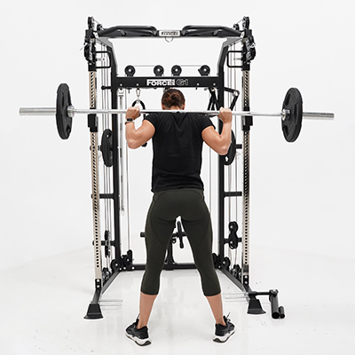 User performing barbell back squats with the Force USA G1 V2 All-In-One Trainer 