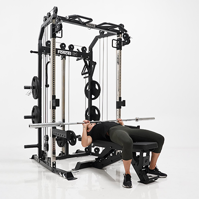 User performing bench press on the Force USA G1 V2 All-In-One Trainer