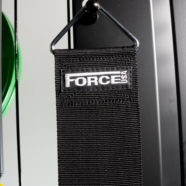 Lifestyle image of the Force USA Bodyweight Assistance Strap hanging on a pegboard