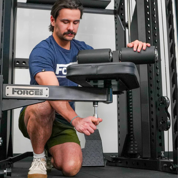 User adjusting height on the Force USA Swivel Seat