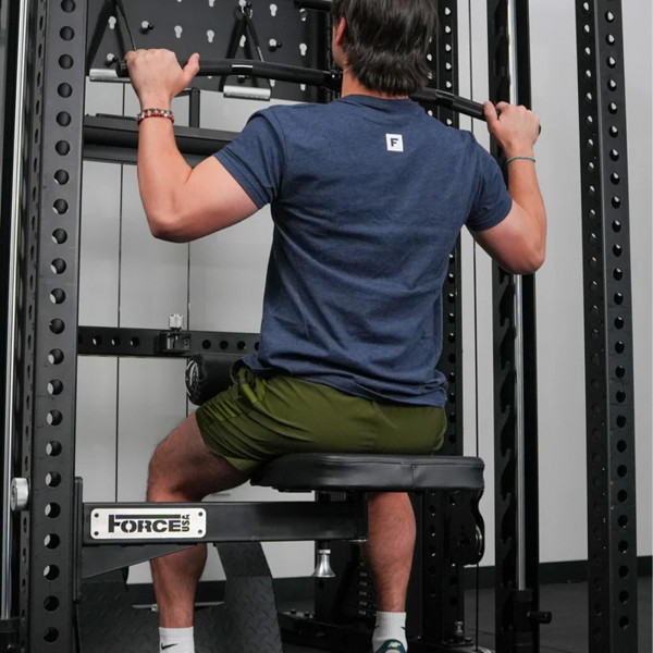 User performing lat pulldown on the Force USA Swivel Seat (rear view)
