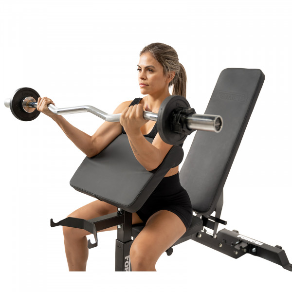 Image of a model performing preacher curls on the Force USA MyBench V2