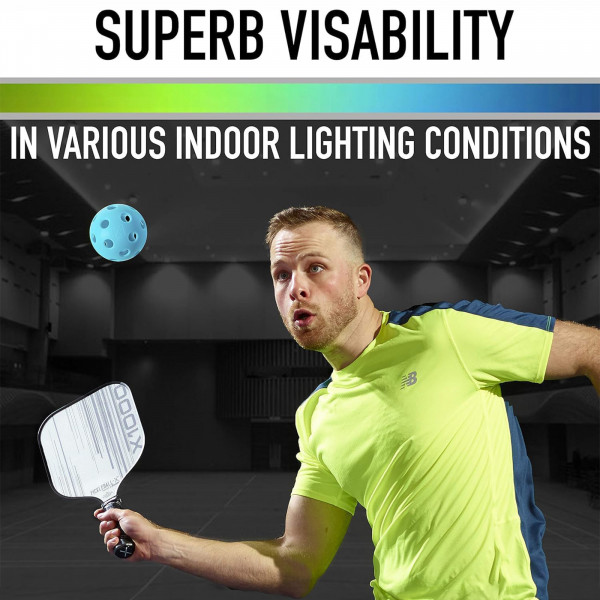 Person playing pickleball with blue Franklin X-26 ball in indoor lighting