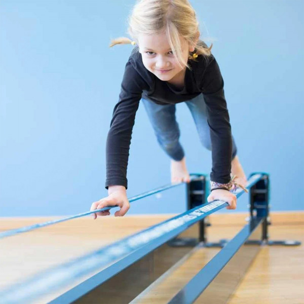 Child balancing on Gibbon Slackrack Fitness using hands and feet