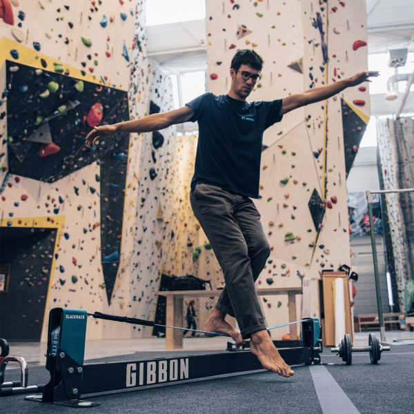 User balancing on the Gibbon Slackrack Fitness indoors