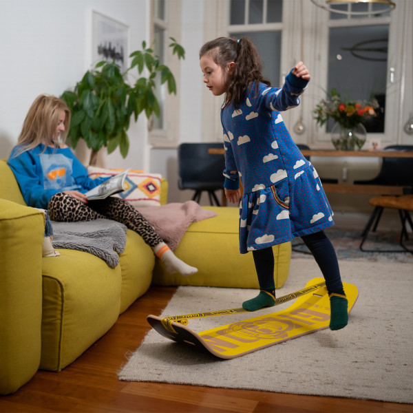 Child balancing indoors on the Gibbon Giboard Set Bonzo Classic