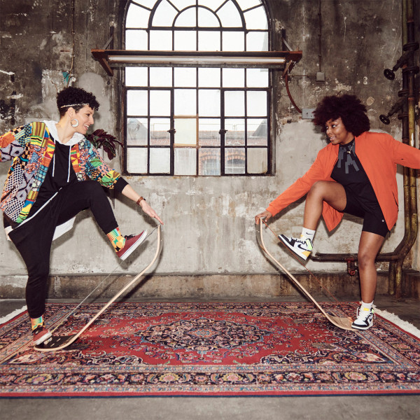 Two people performing tricks indoors on Gibbon Giboard Set Caesar Jib boards