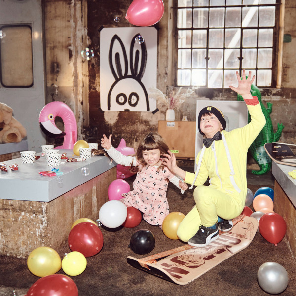Child playing on Gibbon Giboard Set Roots Rocker Travel at a party
