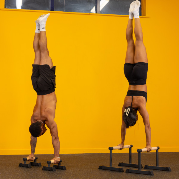 Gravity Fitness Parallettes - Medium - Lifestyle Image - Models performing handstands on the product