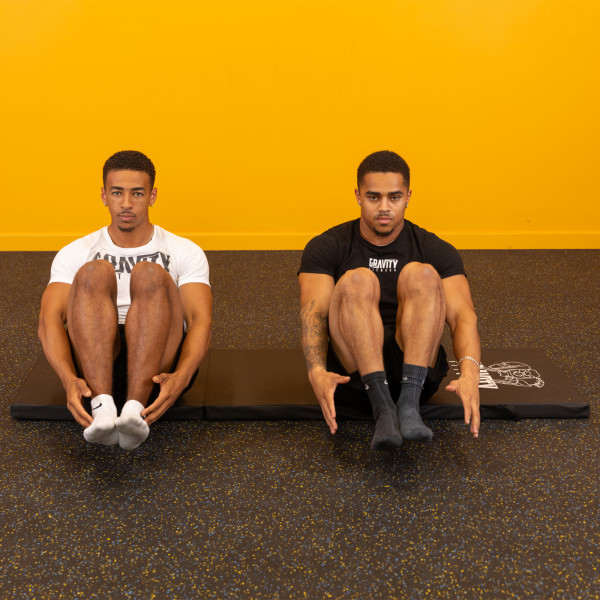 Lifestyle image of the Gravity Fitness Tri-Folding Fitness Mat - v-sit