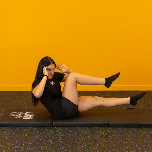 Lifestyle image of the Gravity Fitness Tri-Folding Fitness Mat - twisting crunch