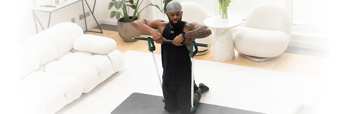 Banner image of a model performing an upright row with the GymProLuxe All-in-One Gym