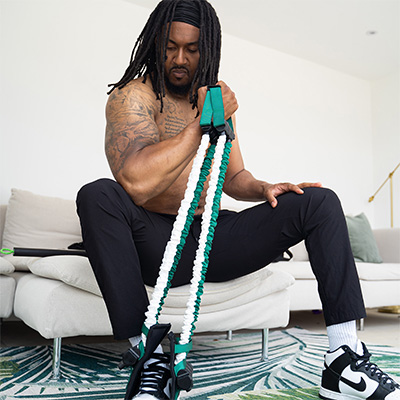 Model using the Gymproluxe for bicep curls