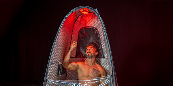 Lifestyle image of a model adjusting the light in the GymProLuxe Tropical Sauna Pod