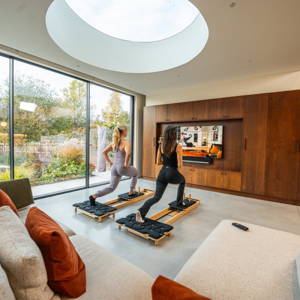 Gymproluxe Portable Pilates Reformer in use during a guided workout