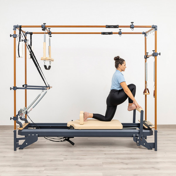 Hip flexor stretch with front foot on footbar on the HEGREN TALMA 62CR Cadillac Reformer