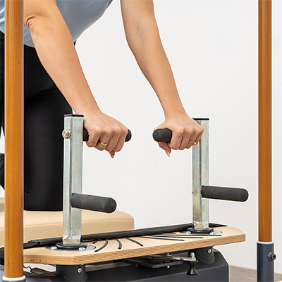 Close-up of the push-through bar grips on the HEGREN TALMA 62CR Cadillac Reformer