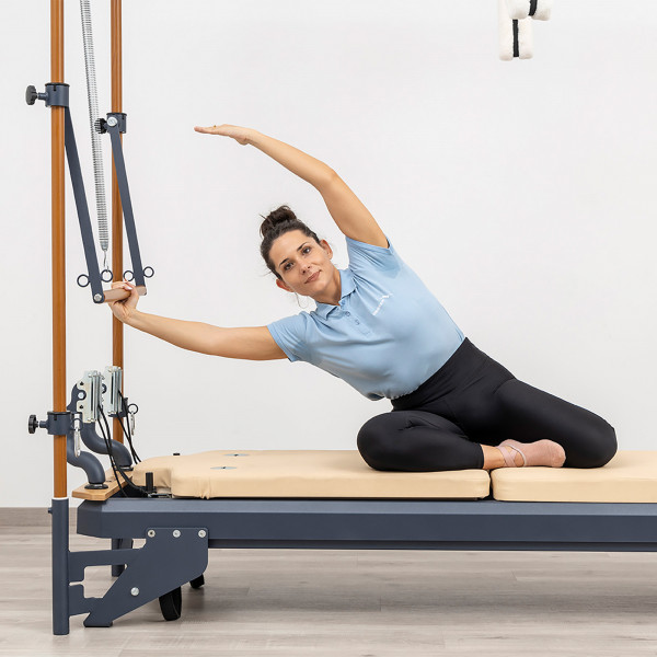 Side stretch using push-through bar on the HEGREN TALMA 62CR Cadillac Reformer