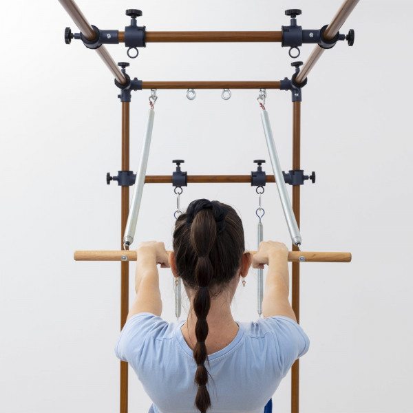 Back view of push-through bar exercise on the HEGREN TALMA TRC Cadillac Trapeze