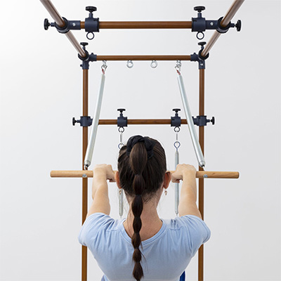 Back view of push-through bar exercise on the HEGREN TALMA TRC Cadillac Trapeze