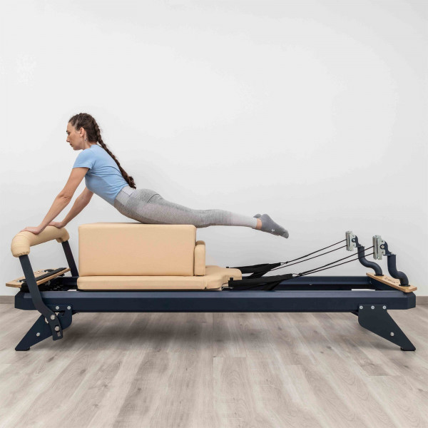 Side view of the HEGREN Modern Pilates Box in beige during prone extension