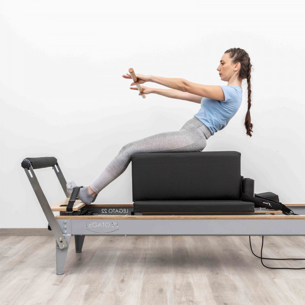 Side view of the HEGREN Modern Pilates Box in black during seated arm work