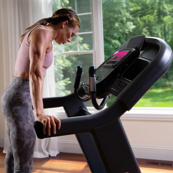 Person resting on the Horizon 7.4AT Treadmill after a workout.