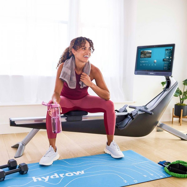 User taking a break between rowing sessions on the Hydrow Pro Rower.