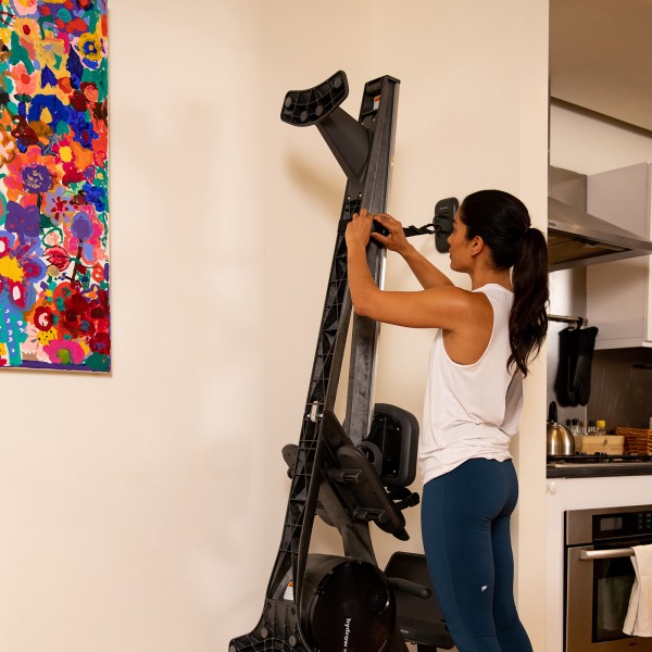 Hydrow Wave Rower folded against a wall.