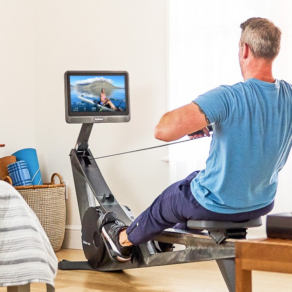 User actively rowing on the Hydrow Wave Rower.