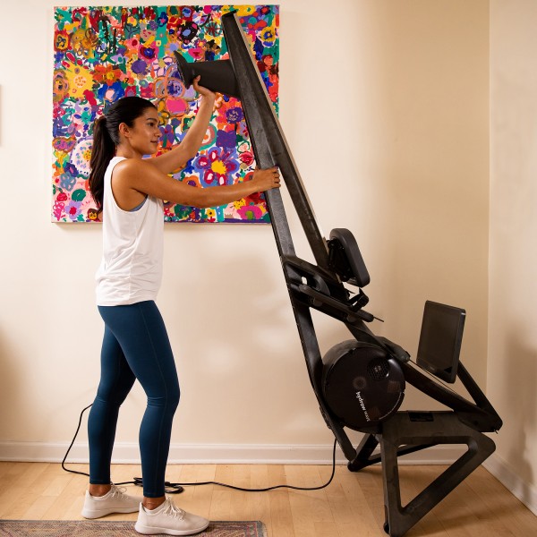 User storing the Hydrow Wave Rower.