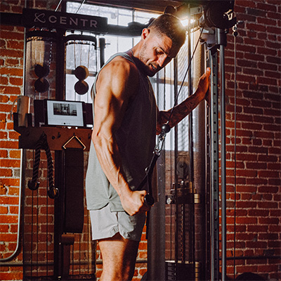 Image of a model performing a tricep pull down with the SF6