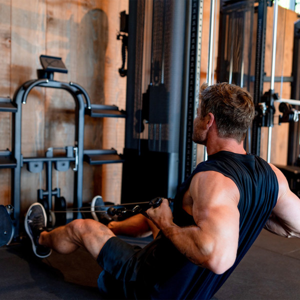 Chris Hemsworth performing a seated lat row using the Inspire Fitness FT2 PRO Functional Trainer.
