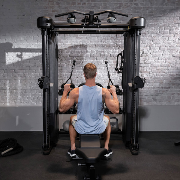 A person doing a lat pulldown on the Inspire Fitness FT2 PRO Functional Trainer.