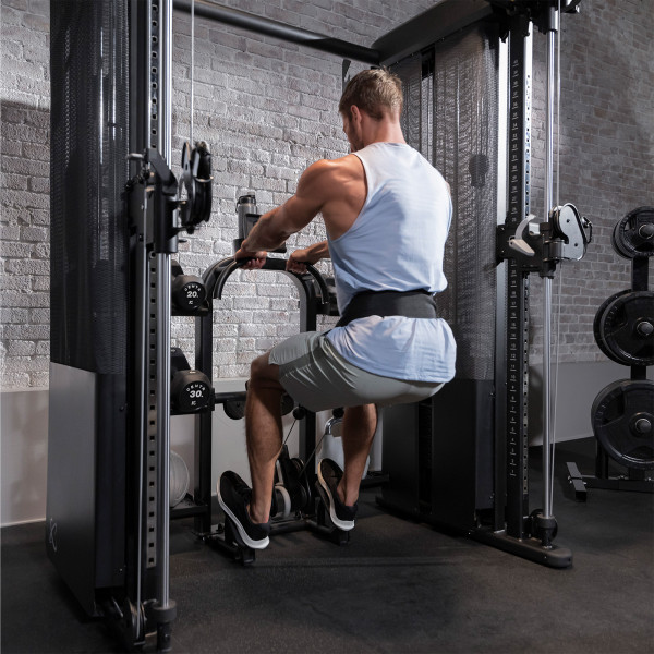 A person using the Inspire Fitness FT2 PRO Functional Trainer for a seated calf raise.