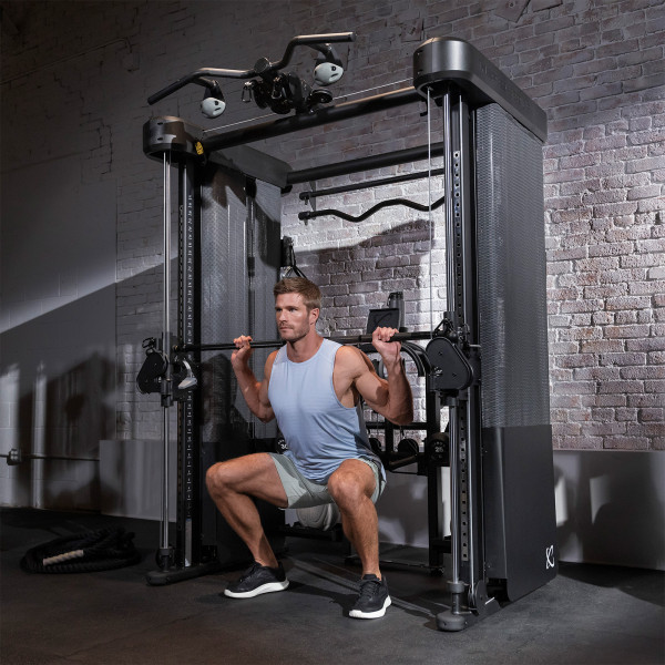 A person performing a squat using the Smith Bar on the Inspire Fitness FT2 PRO Functional Trainer.
