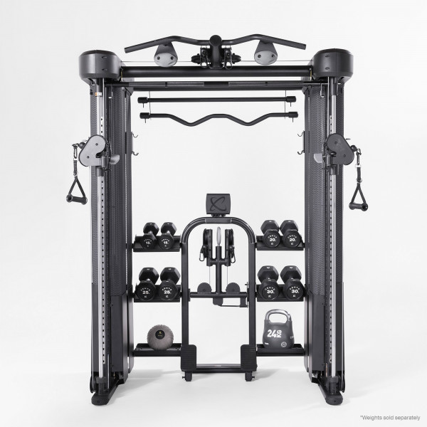 Inspire Fitness FT2 PRO Functional Trainer with dumbbells, kettlebell, and weight accessories stored on integrated shelves.