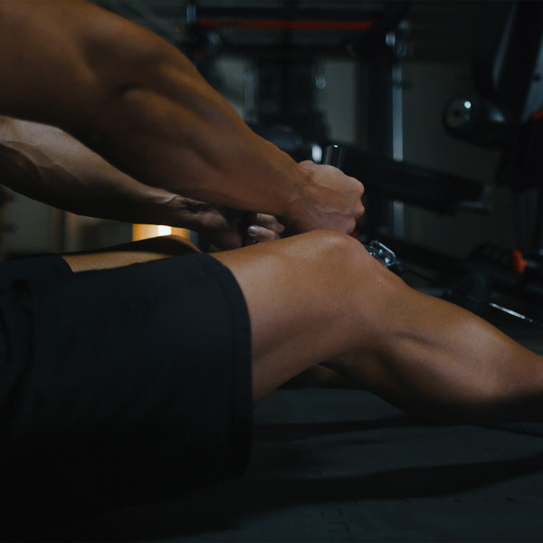 A person performing a seated row on the Inspire Fitness M5 Multi-Gym.