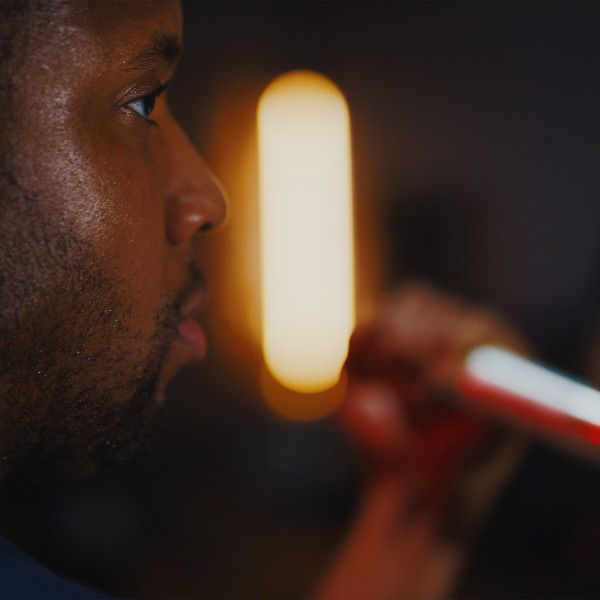 A close-up of a person gripping a bar during a strength workout.
