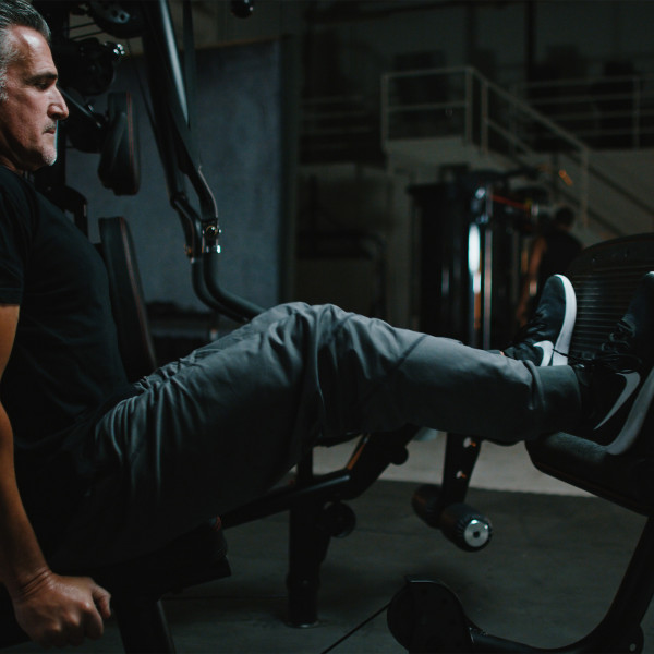 Close-up of a person using the Inspire Fitness Leg Press for M2, M3, M5 Multi-Gym.