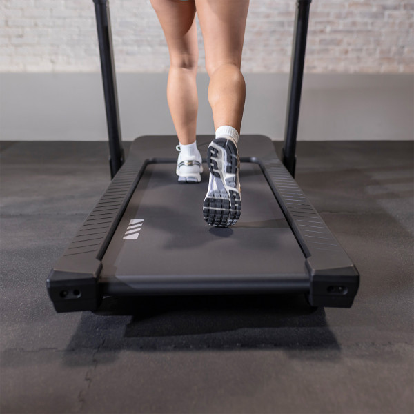 Close-up of user’s feet on the Inspire Fitness Series T4 Treadmill